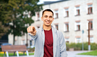 Image showing man pointing finger to you over campus background