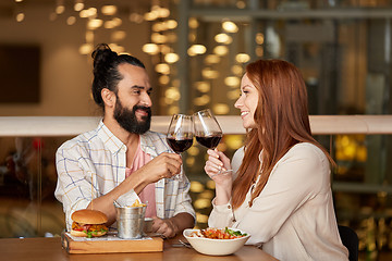 Image showing couple eating and drinking red wine at restaurant