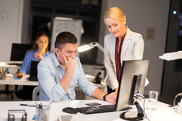 Image showing business team with computer working late at office