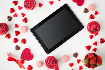Image showing close up of tablet pc and sweets on valentines day