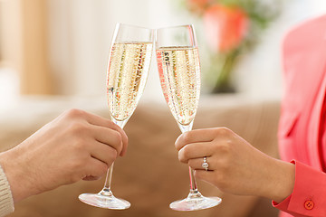 Image showing close up of couple clinking champagne glasses