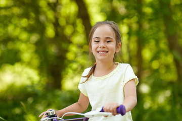 Image showing happy little girl with bicycle in summer