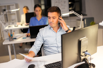 Image showing man calling on smartphone at night office