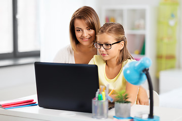 Image showing mother and daughter with laptop doing homework