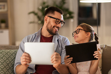 Image showing father and daughter with tablet computers at home