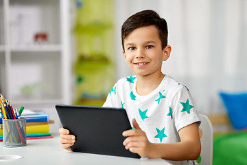 Image showing student boy with tablet pc and notebook at home