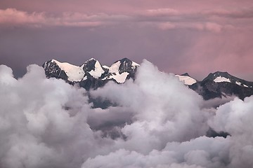 Image showing Mountain peaks above moving clouds