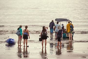 Image showing Boarding a boat on the beach