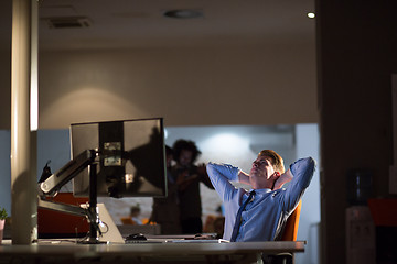 Image showing businessman relaxing at the desk