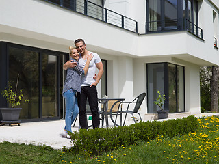 Image showing couple hugging in front of  new luxury home