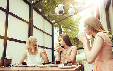 Image showing Two girl friends spend time together drinking coffee in the cafe, having breakfast and dessert.