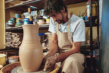 Image showing Creating a jar or vase of white clay close-up. Master crock.