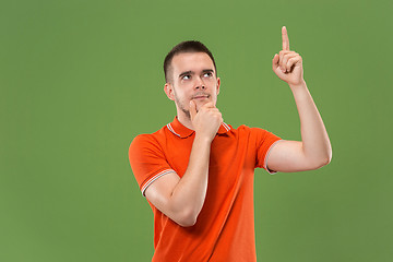 Image showing Young serious thoughtful businessman. Doubt concept.