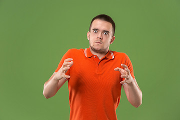 Image showing The young emotional angry and scared man standing and looking at camera