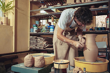 Image showing Creating a jar or vase of white clay close-up. Master crock.