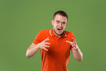 Image showing The young emotional angry and scared man standing and looking at camera