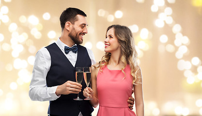 Image showing happy couple with champagne glasses toasting