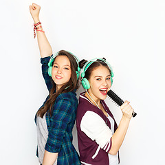 Image showing teenage girls in earphones listening to music