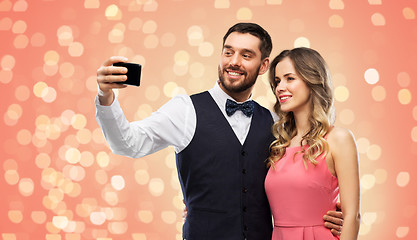 Image showing happy couple taking selfie by smartphone