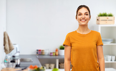 Image showing teenage girl in orange t-shirt over kitchen