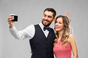 Image showing happy couple taking selfie by smartphone