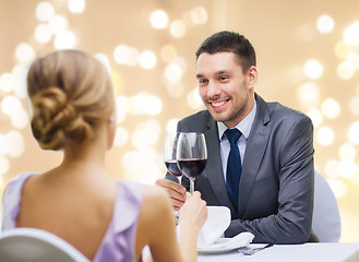 Image showing young couple with glasses of wine at restaurant