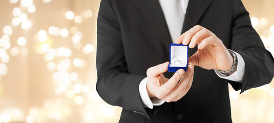 Image showing man with diamond engagement ring in red gift box