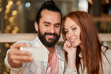 Image showing couple taking selfie by smartphone at restaurant