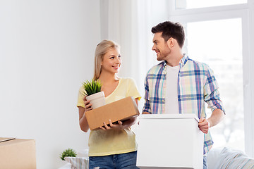 Image showing happy couple with boxes moving to new home