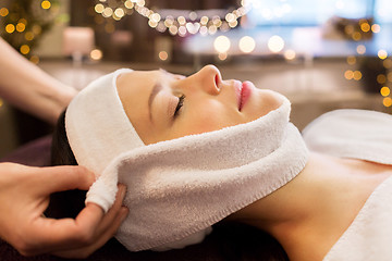 Image showing woman having face massage with towel at spa