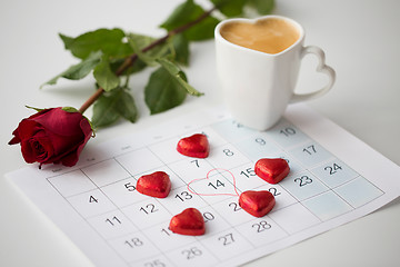 Image showing close up of calendar, hearts, coffee and red rose