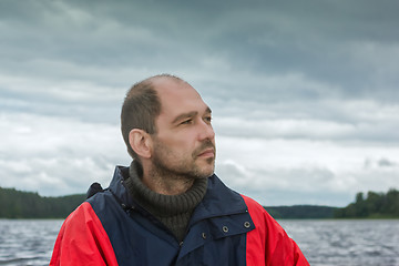 Image showing Conceptual Portrait Of A Pensive Bearded Man Against A Overcast 