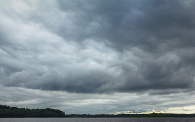 Image showing Dramatic Overcast Sky With Thunderclouds Over The Lake