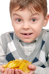 Image showing Little boy is eating chips