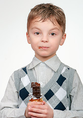 Image showing Little boy eating chocolate