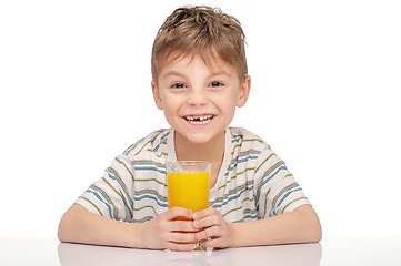 Image showing Little boy with orange juice