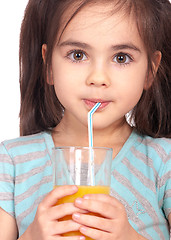 Image showing Little girl drinking orange juice