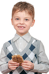 Image showing Little boy eating Kozinaki