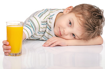 Image showing Little boy with orange juice