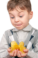 Image showing Little boy is eating chips