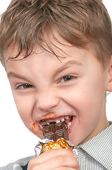 Image showing Little boy eating chocolate