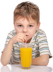 Image showing Little boy with orange juice