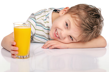 Image showing Little boy with orange juice