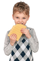 Image showing Little boy eating waffle