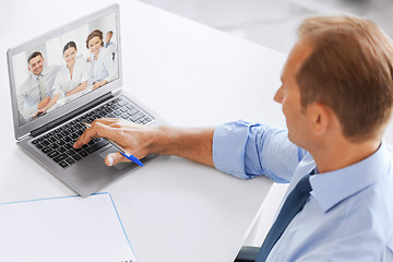 Image showing businessman having video conference at office