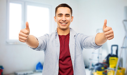 Image showing happy young man showing thumbs up over home repair