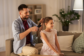 Image showing father brushing daughter hair at home