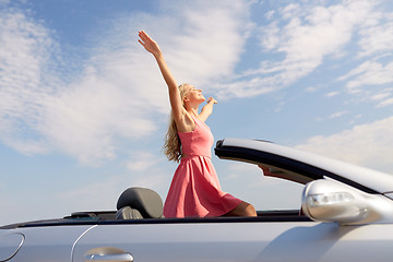 Image showing happy young woman in convertible car