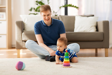 Image showing happy father with little baby son playing at home