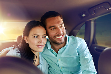 Image showing happy man and woman riding in a taxi back seat